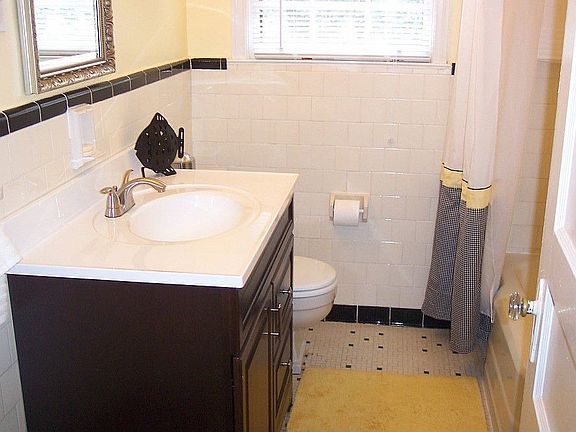 Updated bathroom on main features brand new vanity, mirror, and all new fixtures. Period tile floor 