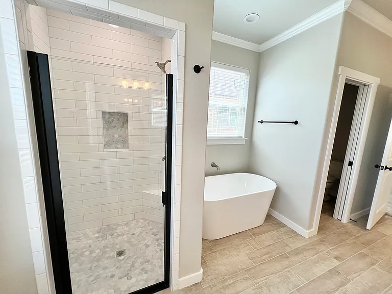 Shower, freestanding bathtub, and private water closet