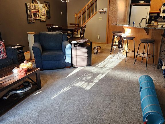 Open concept living space on the main level. Living room with gas fireplace, dining area, pantry closet and kitchen, plus a half bath.
