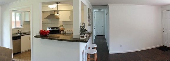Open great room plan with lots of natural light and easy access to the rear yard through French doors!