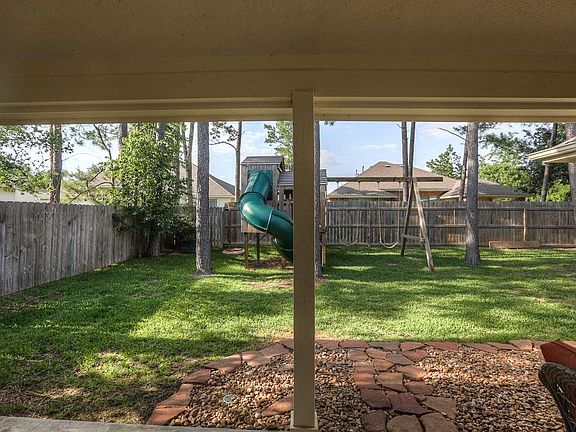 Privacy fence surrounding back yard with several shade trees. Perfect back yard for children.