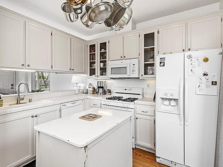 Kitchen has gas range, stove, new microwave, dishwasher, refrigerator and garbage disposal.