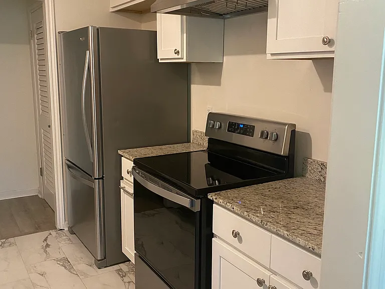Kitchen _ refrigerator, range, and pull-out trash & recycling bins