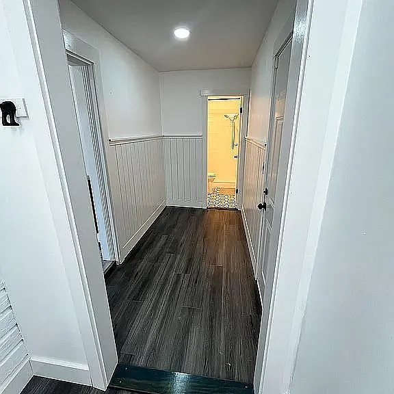 back hallway looking from laundry area to 2nd bathroom.