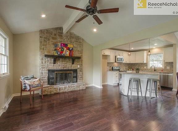 Floor to ceiling stone hearth, vaulted ceiling.