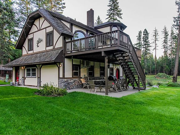 Southwest view of home exterior. There is a lovely, sunny deck upstairs and a covered patio / bbq area downstairs.