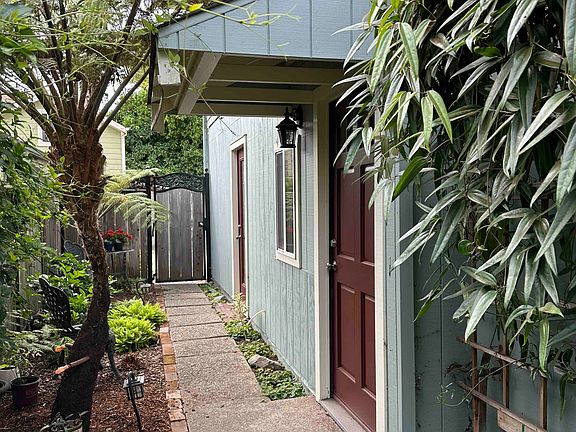Unit entrance, seating area, plantings