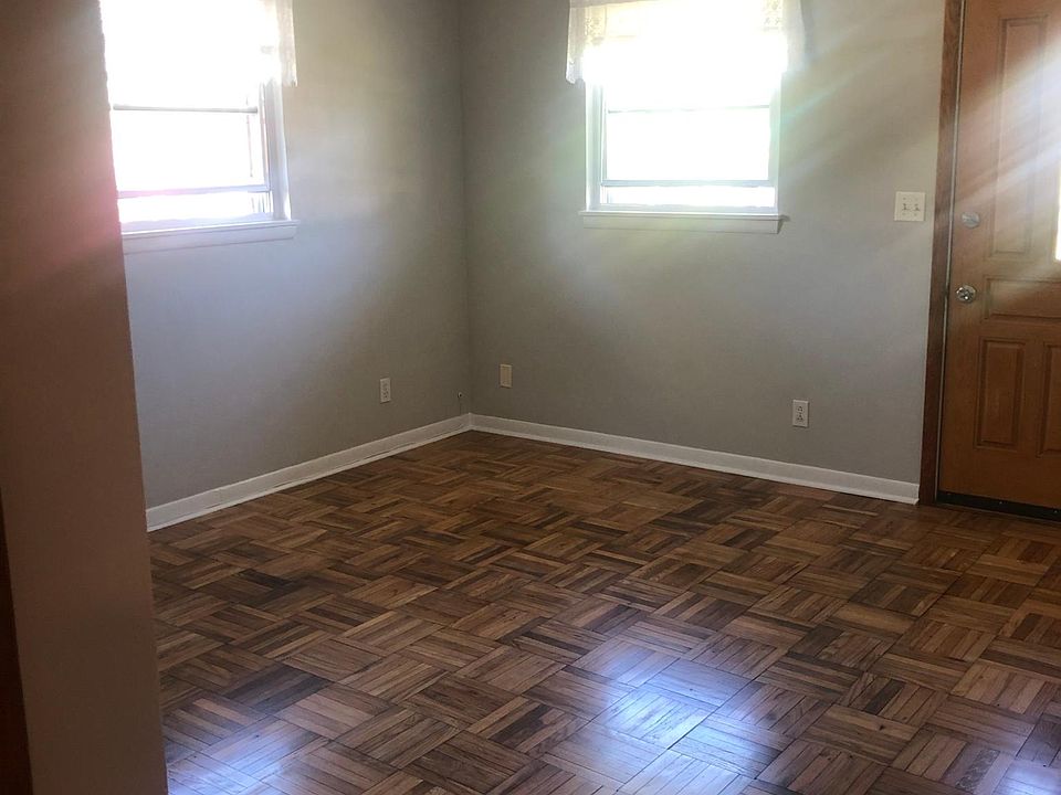 Living area with newly refinished hardwood parquet flooring.