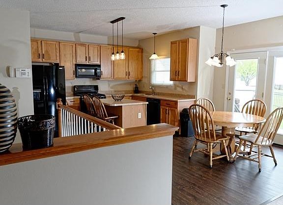 Kitchen with French doors leading to patio and fenced back yard.