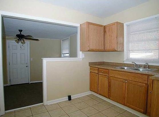 Kitchen (electric stove coming) opens to family room for com