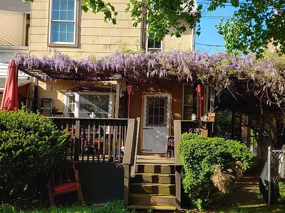 Rear deck with wisteria trellis in bloom