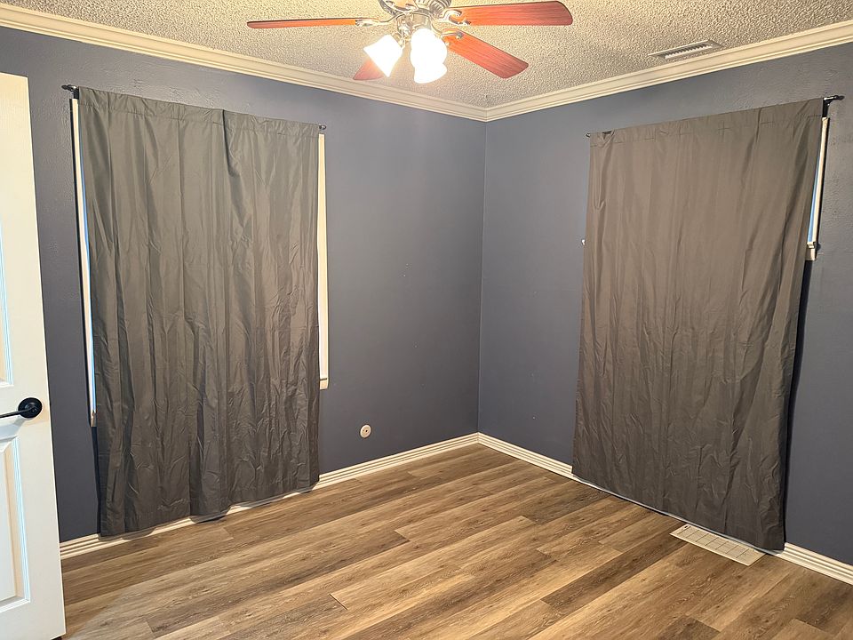 Bedroom with curtains drawn, easily fits queen bed