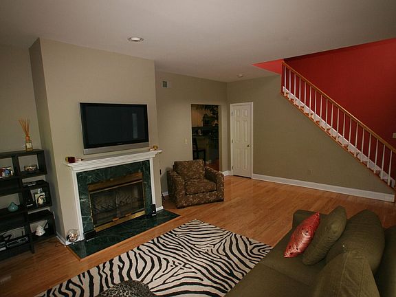 Living Room Features Marble-Surround Fireplace