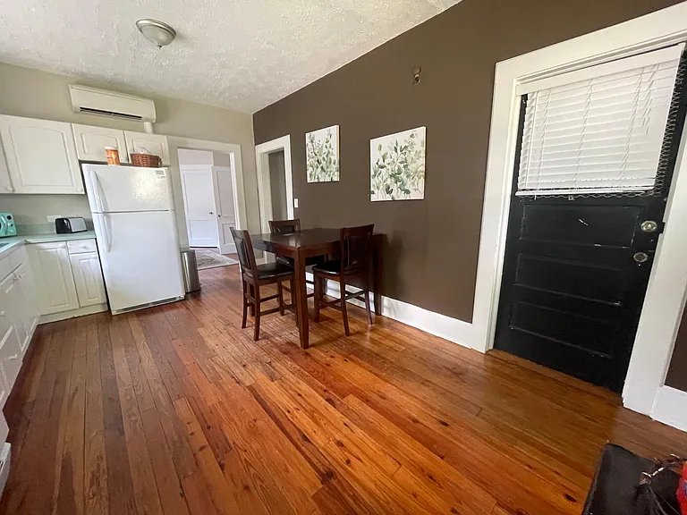 Table and chairs in the kitchen for dining.