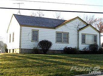 Steel siding, vinyl windows, detached two car garage to the righ