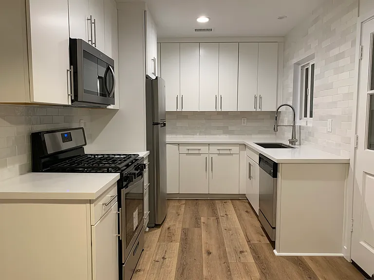 Updated kitchen featuring modern cabinetry, stainless steel appliances and durable flooring.