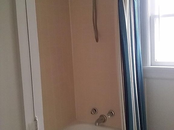 Bathroom has shower over full size bath.