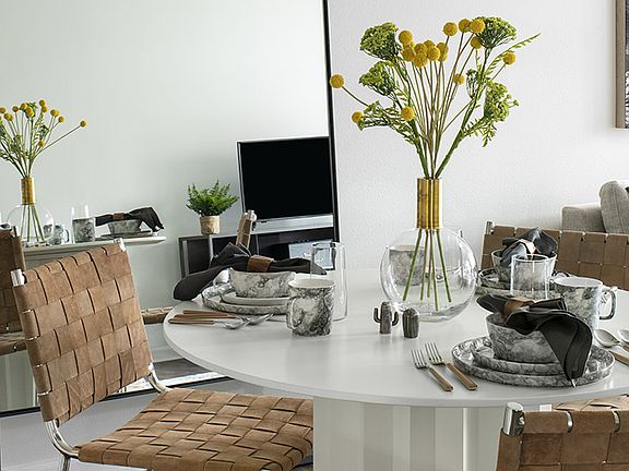 Apartment dining room with wood-style flooring.