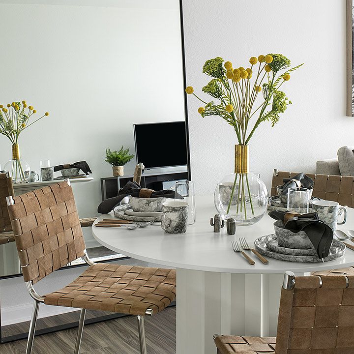 Apartment dining room with wood-style flooring.