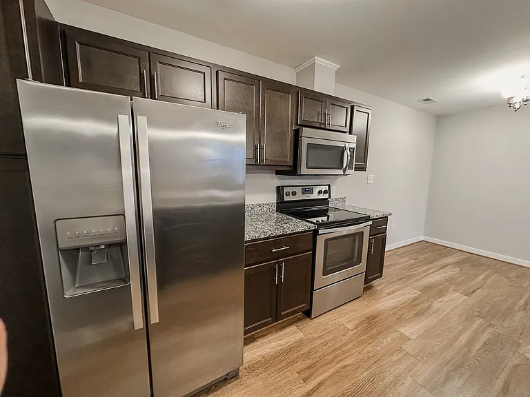 The kitchen features granite countertops and stainless steel appliances.
