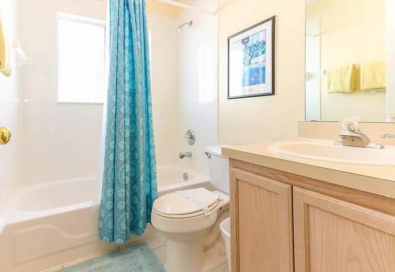 spacious second bathroom with a tub