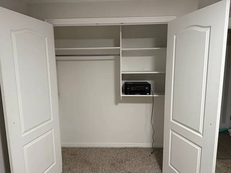 Second bedroom closet with built-in shelving and printer
