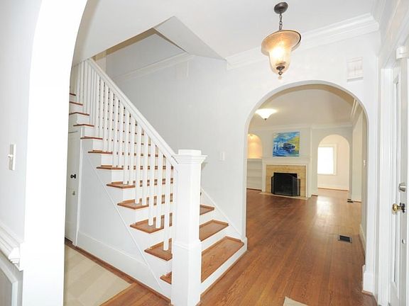 The home is loaded with period character like hardwood floors, archways, crown moulding, and wainscoating.
