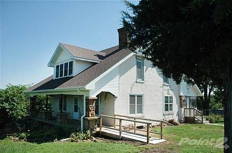 The southwest corner of the house; handicap ramp to the front porch