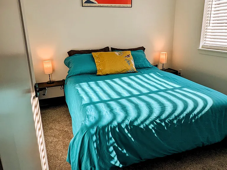 Bedroom with queen bed. Stocked with additional sheets, duvet covers, extra pillows and fan.