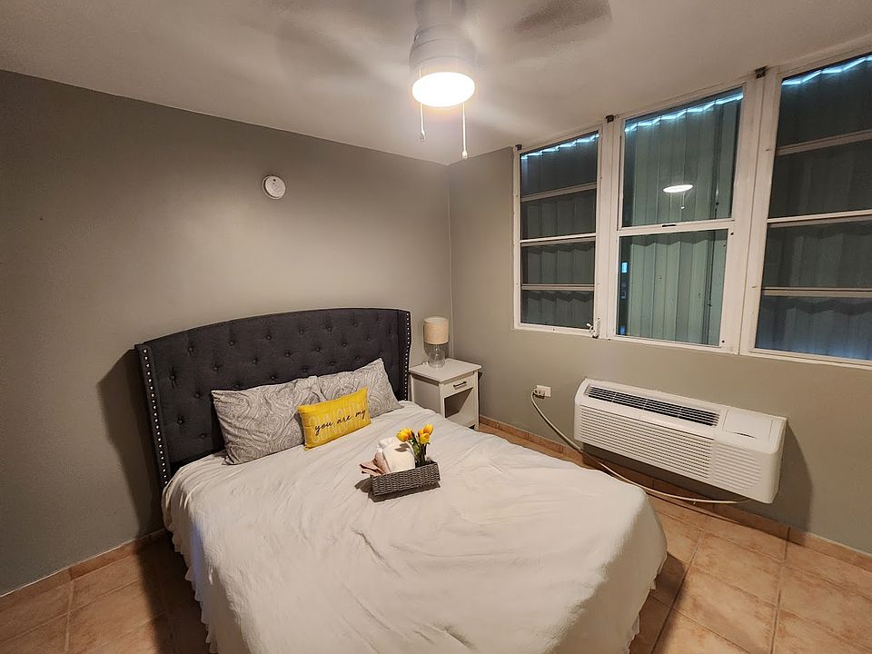 3nd bed room, garden views. furnished with night stand, queen bed and large closet, with fan, and light.