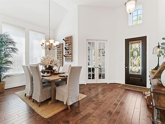 Another view of the dining room that showcases the open entry and beautiful french doors to the study.