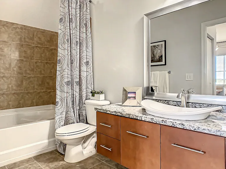 Enjoy an elegant primary bathroom with expansive countertop space, abundant storage, and an oversized garden tub (in select homes).