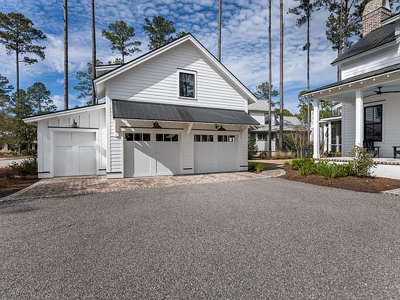 2-car garage, golf car bay, with 1 BDR/1 BA carriage house above.
