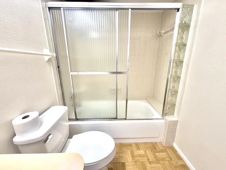 2nd bathroom with enclosed shower and tub.