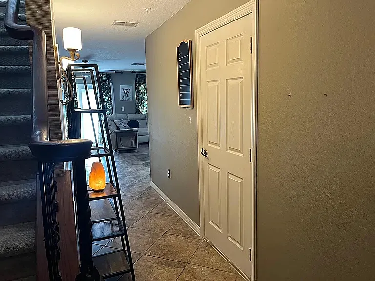 First floor hallway with garage door on right side.