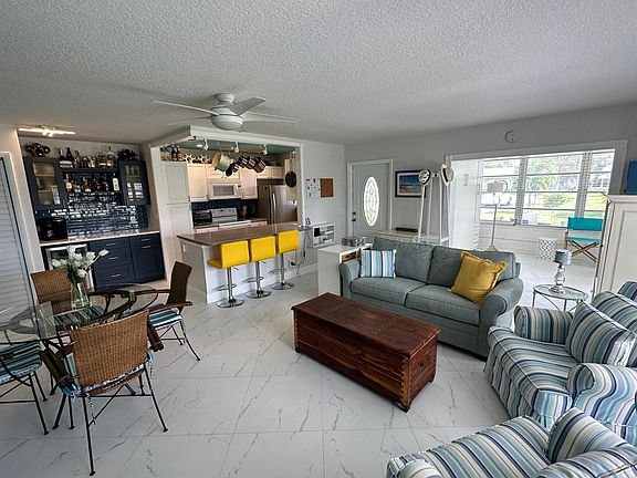 Huge open-concept living, kitchen, dining, & Florida room.