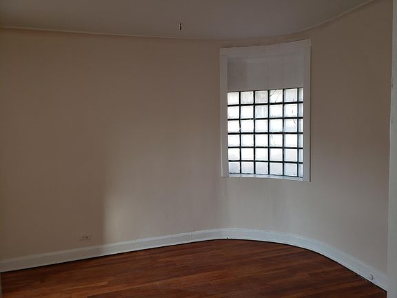 Living room glass block window as viewed looking Northeast from doorway to kitchen.