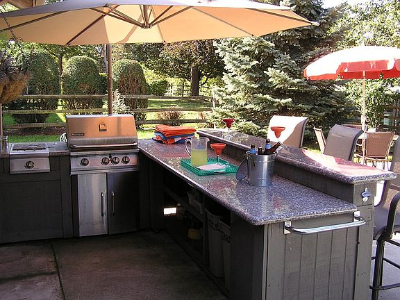 Backyard - Outdoor kitchen, room underneath for mini-fridge, and sound system 