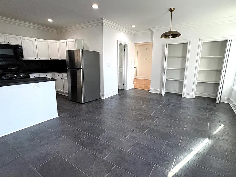 1st Fl - Kitchen (l) with Dining Room (r) with open double pantry closets (c)