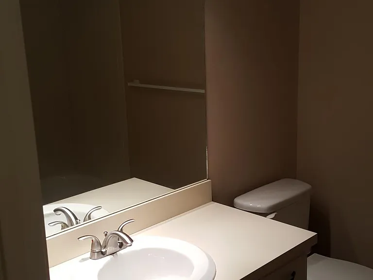 Hall bathroom with bathtub next to the dining room and across from spare bedrooms