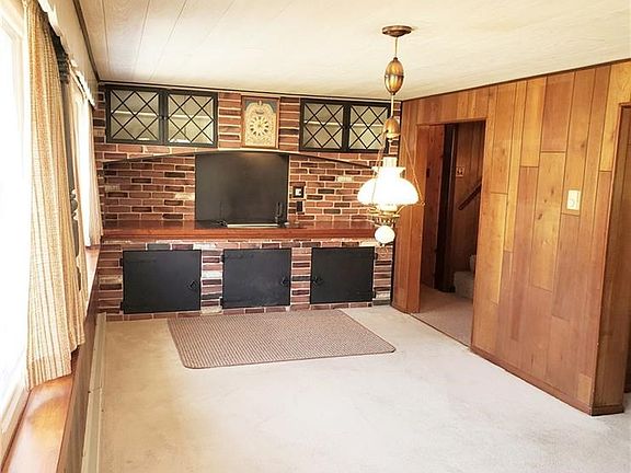 This 19x9 dinning room view is of entering from the formal entrance. This home is installed with a custom indoor charcoal grill with a vent hood (built into upper area). No need to check the weather before your next cook out.
