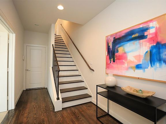 First floor with direct access to and from the garage, gleaming hardwoods and bedroom to the left of the entryway.