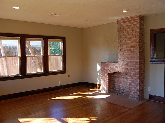 Living room: Restored hardwoods and woodwork with mock firep