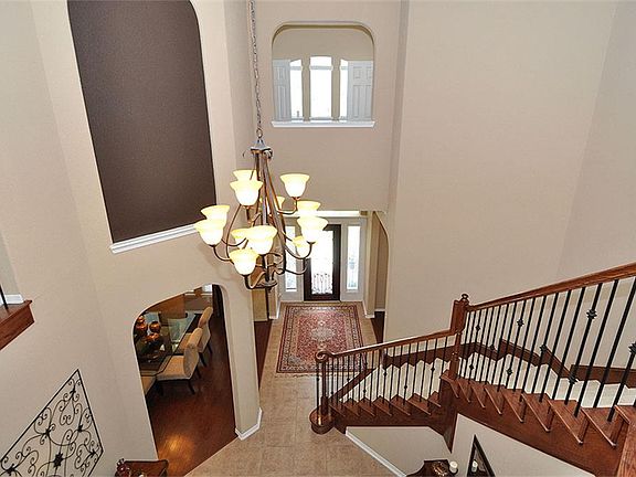 TWO STORY ENTRY & WROUGHT IRON STAIRCASE