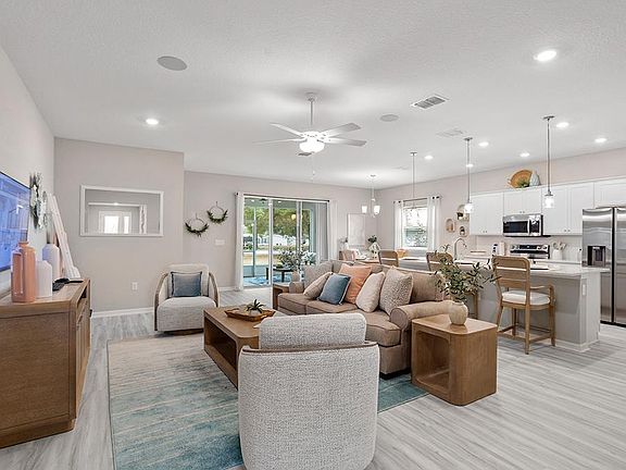 Enjoy your light-filled open living area complete with triple sliding glass door - Aubrey home plan