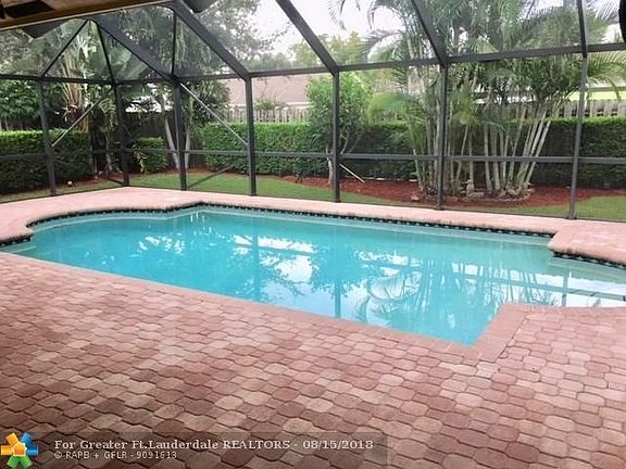 The beautiful pool is surrounded by pavers and has a wonderful screened enclosure.  In the nice weather you can open all sliders