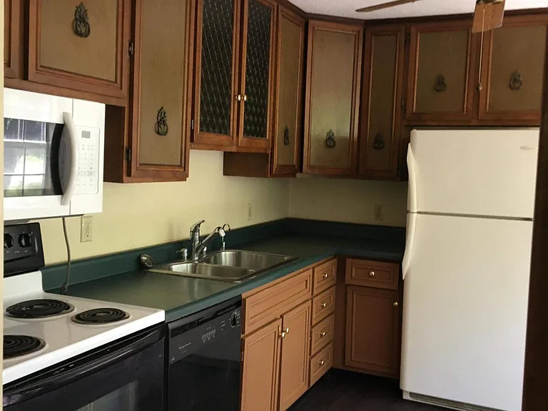 Beautiful vintage cabinets and ceiling fan add lots of charm