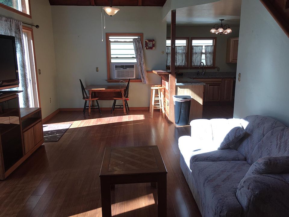 Facing West, looking at dining area and kitchen, stairs are to the left.