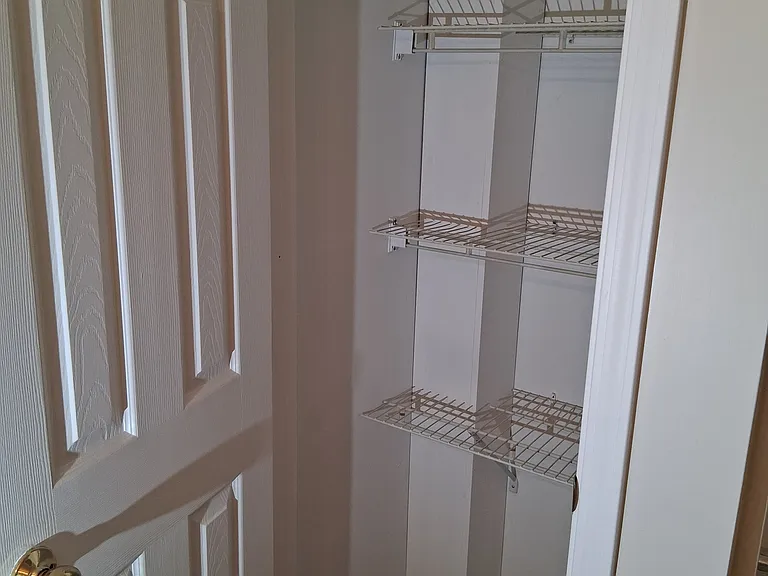 Linen closet located inside hall bathroom