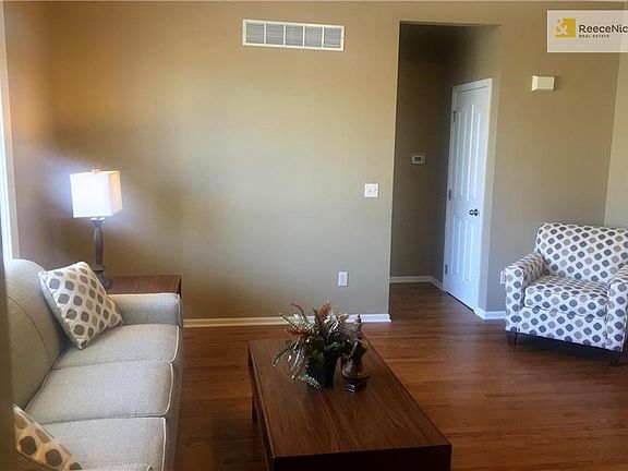 Living room with gleaming hardwood floor.